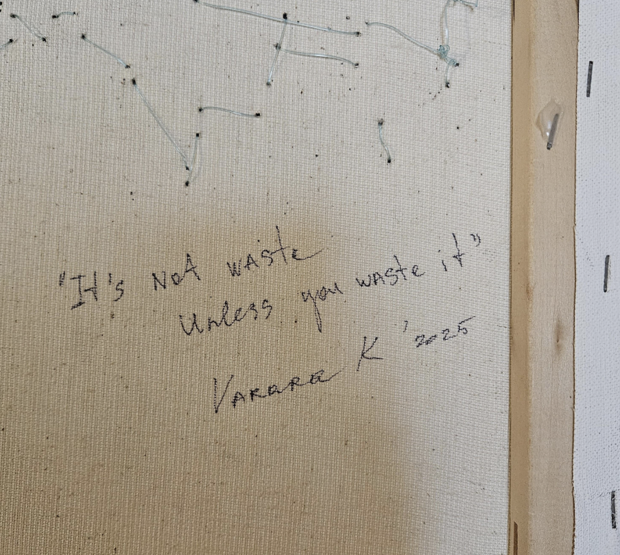 Reverse detail with the handwritten title and signature stitched and inscribed on the canvas