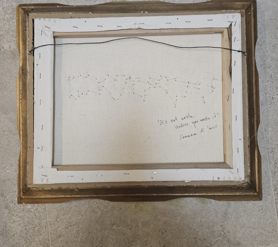 Reverse of the work showing the wire hanging system and repurposed plastic thread stitched across the canvas